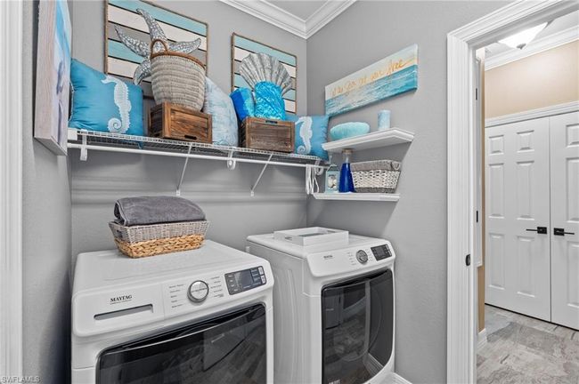 Laundry area featuring crown molding, independent washer and dryer, and baseboards | Image 34