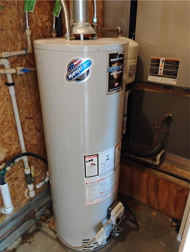 Garage utility room featuring gas water heater | Image 76
