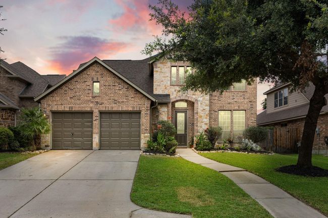 Twilight photo of the front of the home front the road. | Image 4
