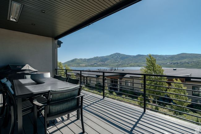 Balcony with a water and mountain view | Image 9