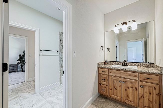 Full bathroom with marble finish floors, vanity, and shower / tub combination | Image 25