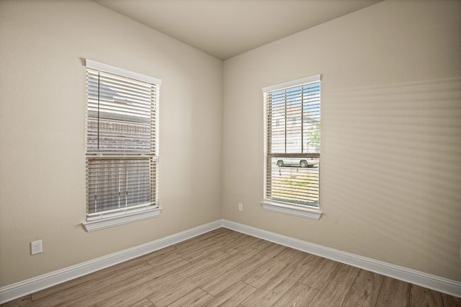 Spare room with wood finished floors and baseboards | Image 11