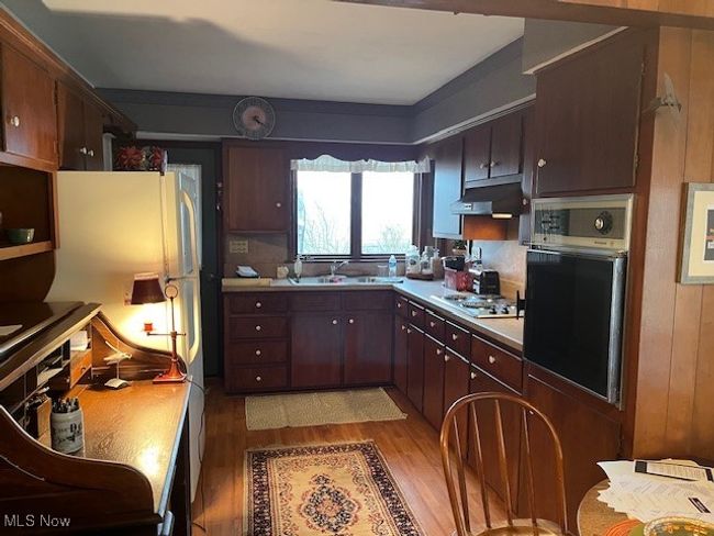 Kitchen featuring built in oven & range top laminate flooring | Image 16