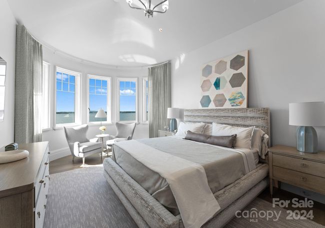 This massive secondary suite has long range lake views, two walk in closets, and a stunning full bathroom. | Image 27