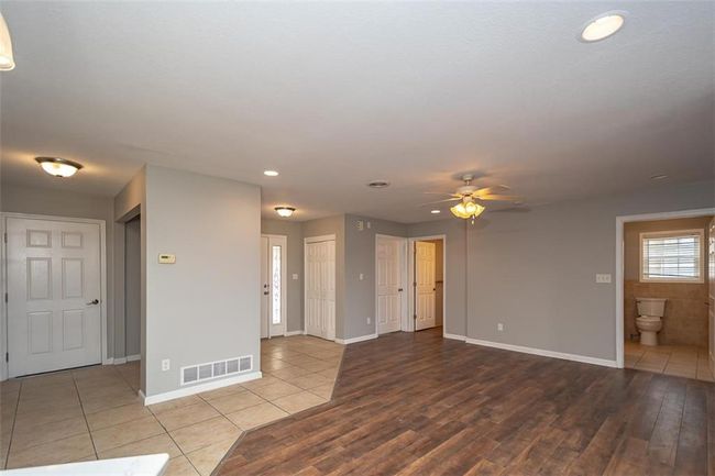 Tiled empty room with recessed lighting, a ceiling fan, visible vents, and baseboards | Image 16