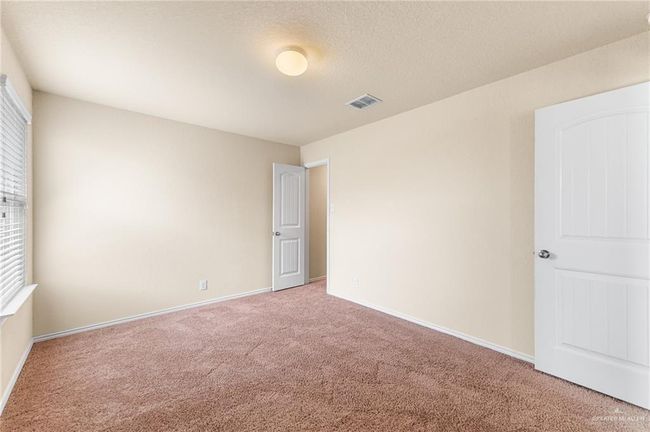 Unfurnished bedroom with carpet flooring and baseboards | Image 22
