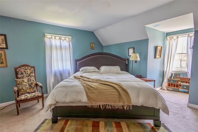 Bedroom with carpet flooring, multiple windows, vaulted ceiling, and baseboards | Image 19