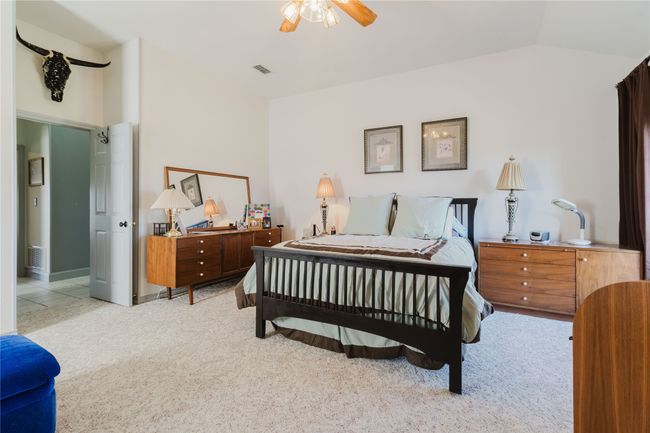 Carpeted bedroom featuring ceiling fan and lofted ceiling | Image 20