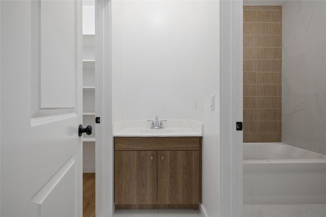 Bathroom featuring vanity and shower / bath combination | Image 26