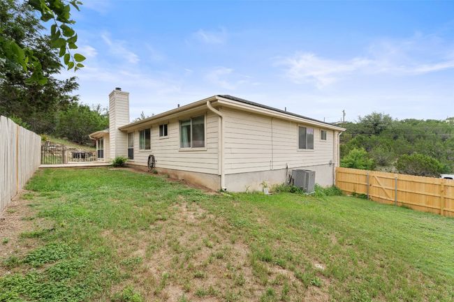 Rear view of house with central AC and a chimney | Image 38