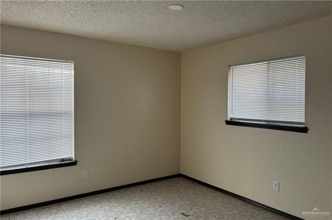 Spare room with a textured ceiling | Image 9