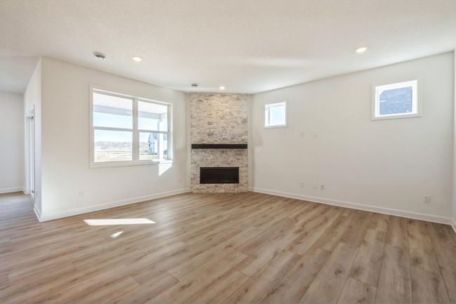 Photo is of the actual home. The Great Room features a full height fireplace! A perfect place to relax and create memories. | Image 6