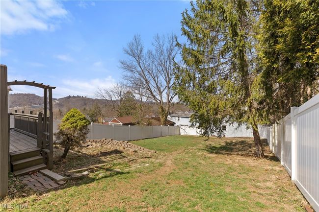 View of yard with a fenced backyard and a wooden deck | Image 22