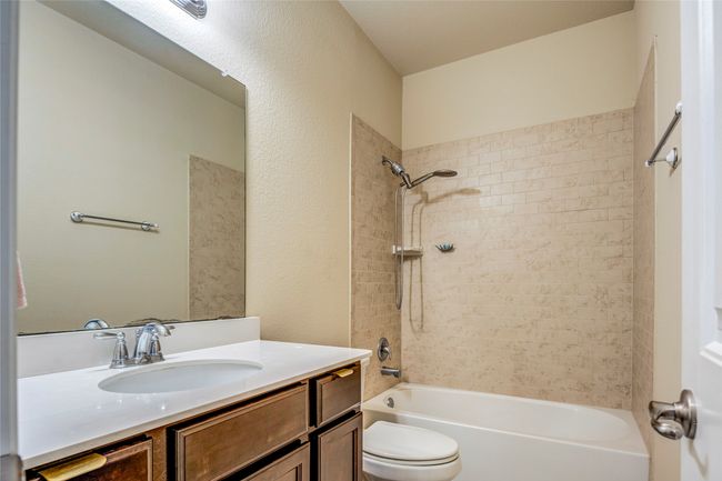 Bathroom featuring bathing tub / shower combination, vanity, and toilet | Image 34