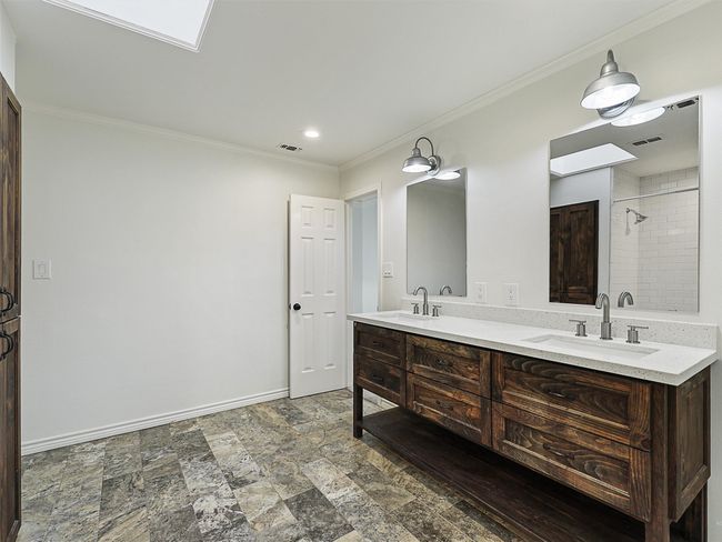 Full bathroom featuring baseboards, visible vents, a sink, and ornamental molding | Image 24
