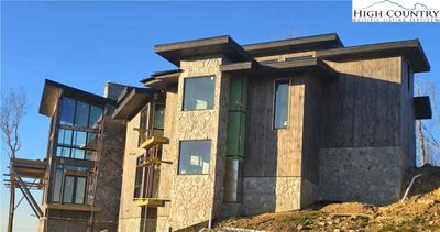 Front Right Side showing Large Family Room Windows and Deck | Image 1