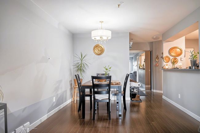 Dining area with a chandelier, baseboards, and wood finished floors | Image 12