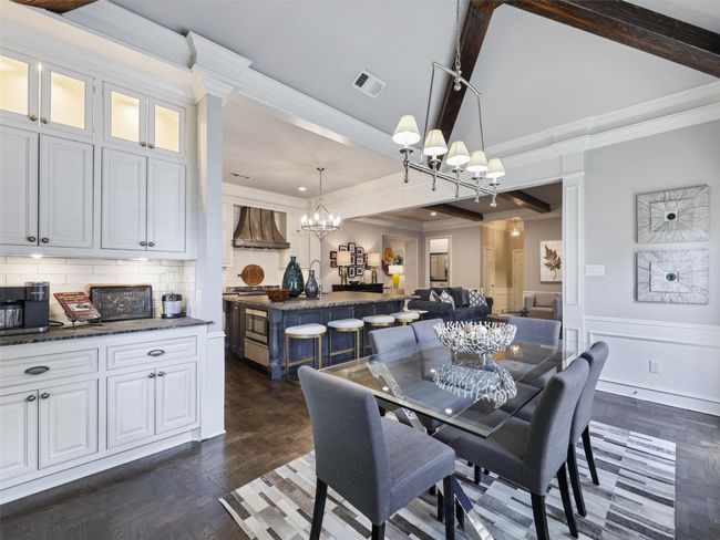 Dining space with a chandelier, ornamental molding, and wainscoting | Image 15