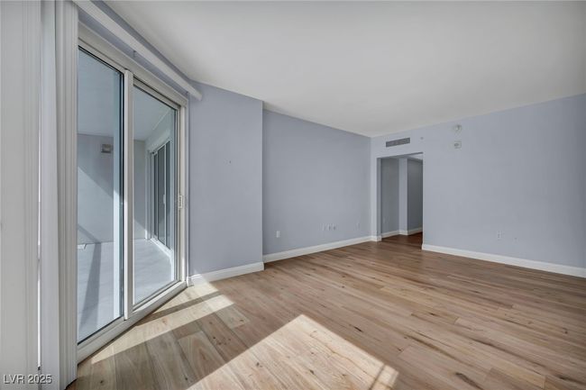 Primary Suite with wood finished floors, visible vents, and baseboards | Image 35