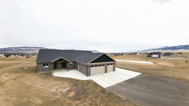 View of front of home featuring a mountain view, an attached garage, board and batten siding, and concrete driveway | Image 34