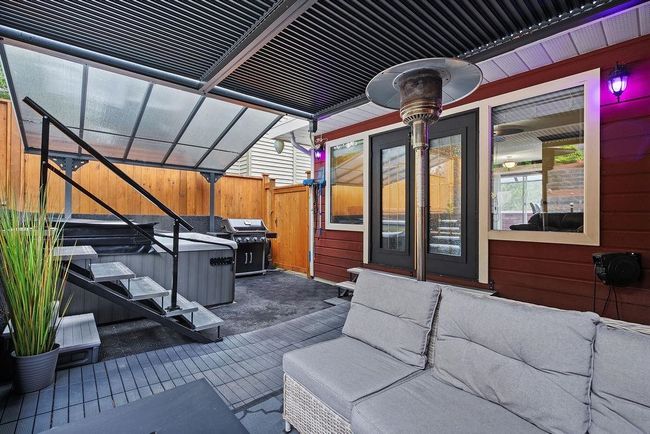 View of patio featuring area for grilling and fence | Image 33