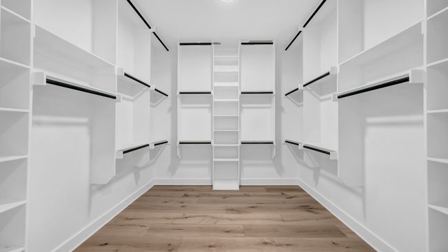Spacious closet featuring light wood-type flooring and a barn door | Image 23