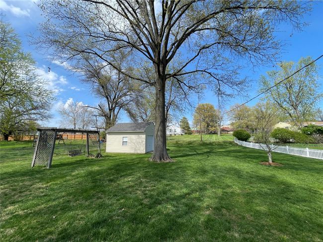 View of yard with an outbuilding and fence | Image 47