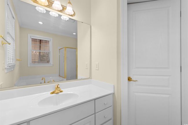Bathroom with vanity, a shower stall, and a bath | Image 17