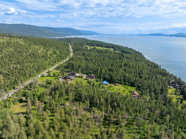 View of property location featuring a heavily wooded area and a water and mountain view | Image 81