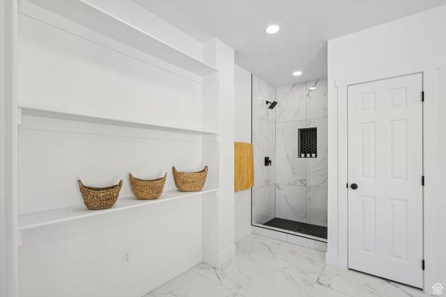 Full bathroom featuring marble finish flooring, a marble finish shower, recessed lighting, and baseboards | Image 23