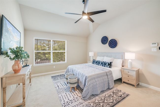 Bedroom featuring vaulted ceiling, light carpet, and a ceiling fan | Image 13