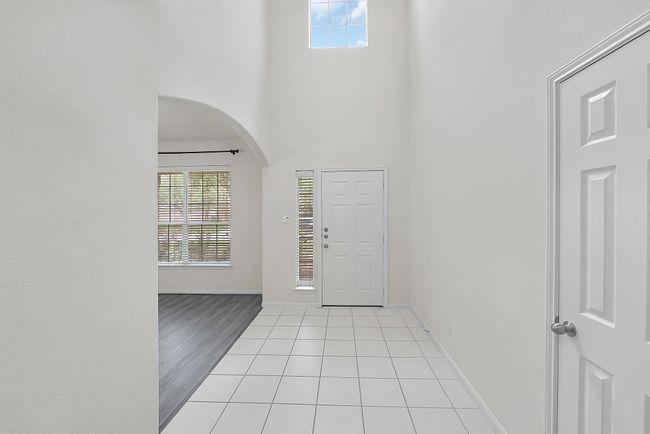 Bright entryway with high ceilings and windows for natural light; such a simple and clean design. | Image 6