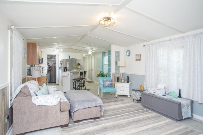 Living room with vaulted ceiling and plenty of natural light | Image 8
