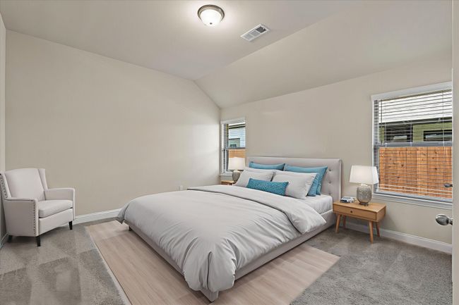 Bedroom with lofted ceiling and light colored carpet | Image 19