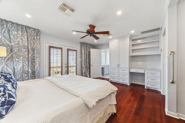 Discover the primary bedroom's elegant built-in shelving, perfect for stylish organization. | Image 25