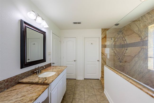 Bathroom featuring visible vents, vanity, and a walk in shower | Image 13