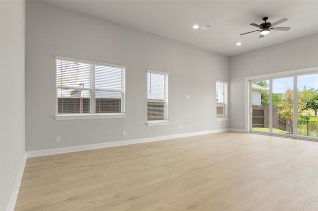 Empty room with light wood finished floors, recessed lighting, and ceiling fan | Image 14