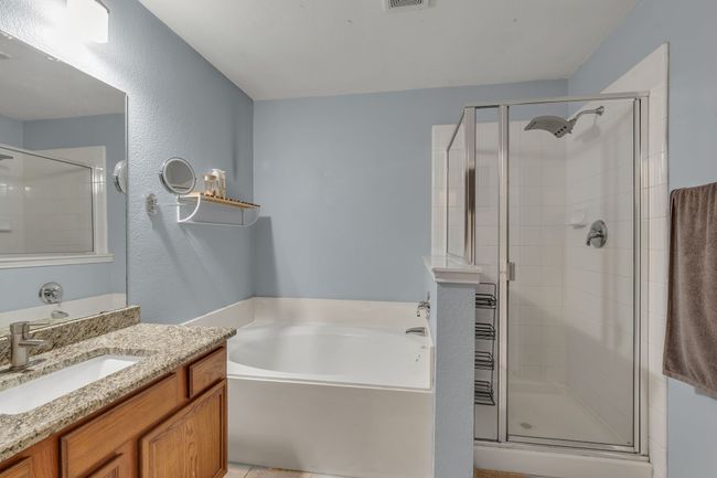 Full bath with a bath, a stall shower, and vanity | Image 22