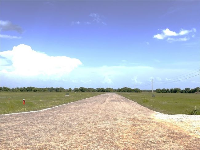 View of asphalt road with a rural view | Image 15