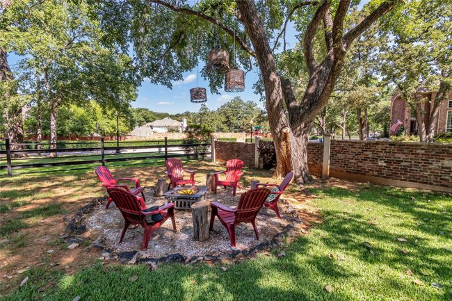 Fenced backyard with an outdoor fire pit | Image 33