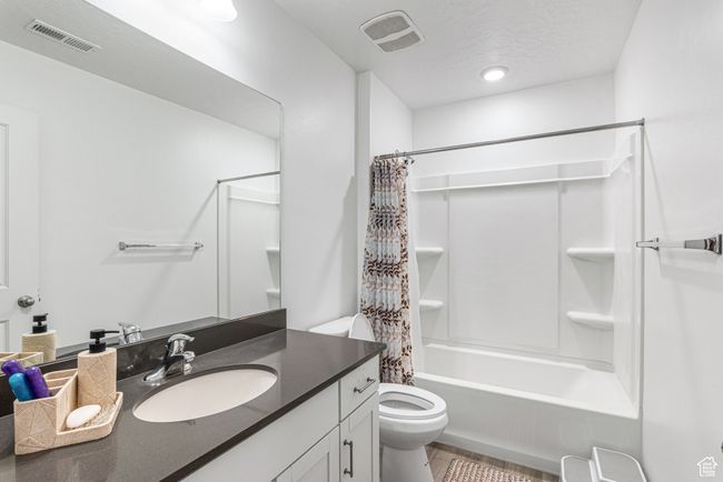 Bathroom featuring toilet, vanity, and shower / bath combo | Image 28