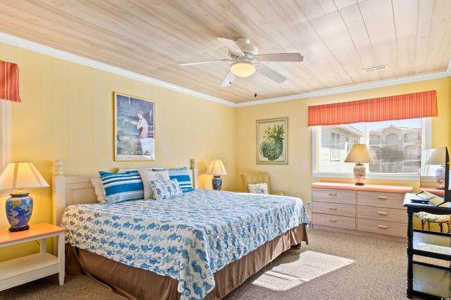 Bedroom featuring carpet, ceiling fan, wooden ceiling, and crown molding | Image 20