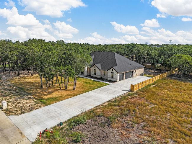 View of front of home with a garage, a shingled roof, and a front lawn | Image 9