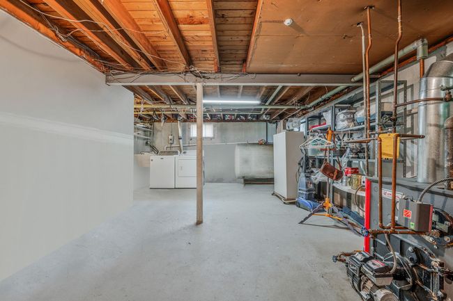 Unfinished below grade area featuring washing machine and dryer | Image 26