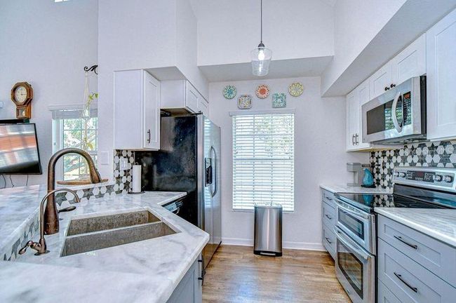 Upgraded Kitchen with Double oven, custom tile backsplash, stainless Microwave. Upgraded new cabinets. | Image 14