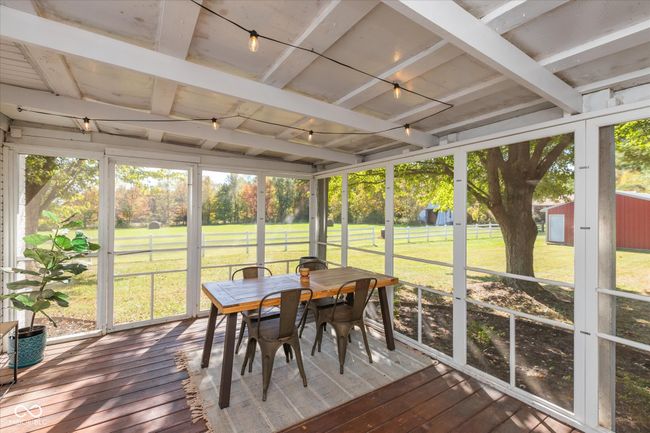 Large screened in patio perfect for relaxing while enjoying the scenic property views. | Image 23