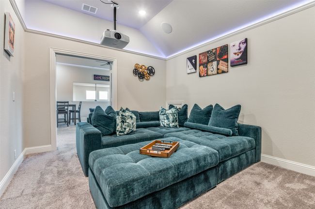Carpeted cinema room with vaulted ceiling and baseboards | Image 20