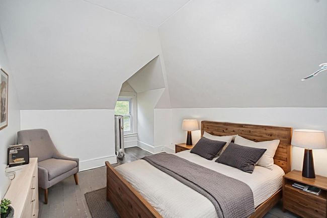 Bedroom with lofted ceiling and wood finished floors | Image 20