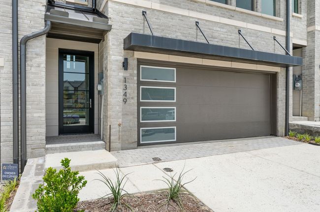 The contemporary entrance in this dream home is the perfect place to welcome family and friends into your new space. | Image 4