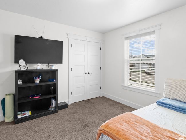 Carpeted bedroom with a closet and baseboards | Image 9